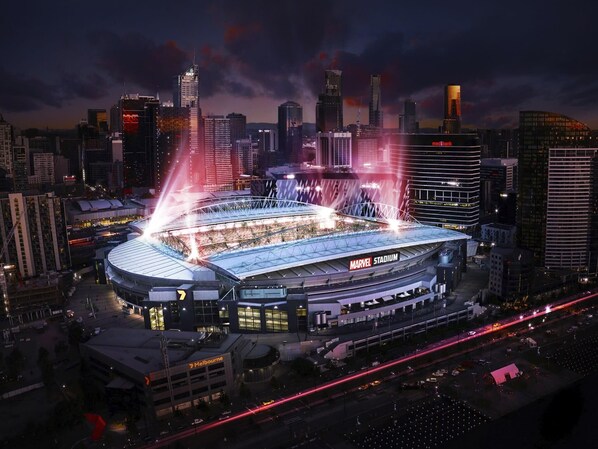 A stadium with a large, curved roof and multiple levels of seating.