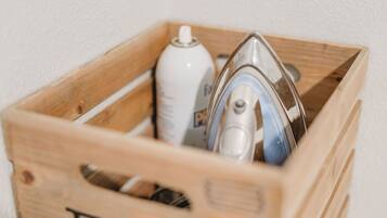 A wooden crate with the word "Fold" on it, containing a spray bottle and a metal object.