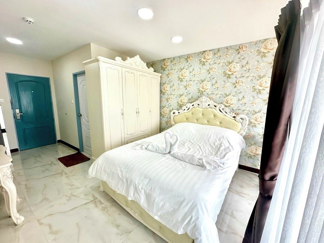 A bedroom with a bed, wardrobe, and a door.