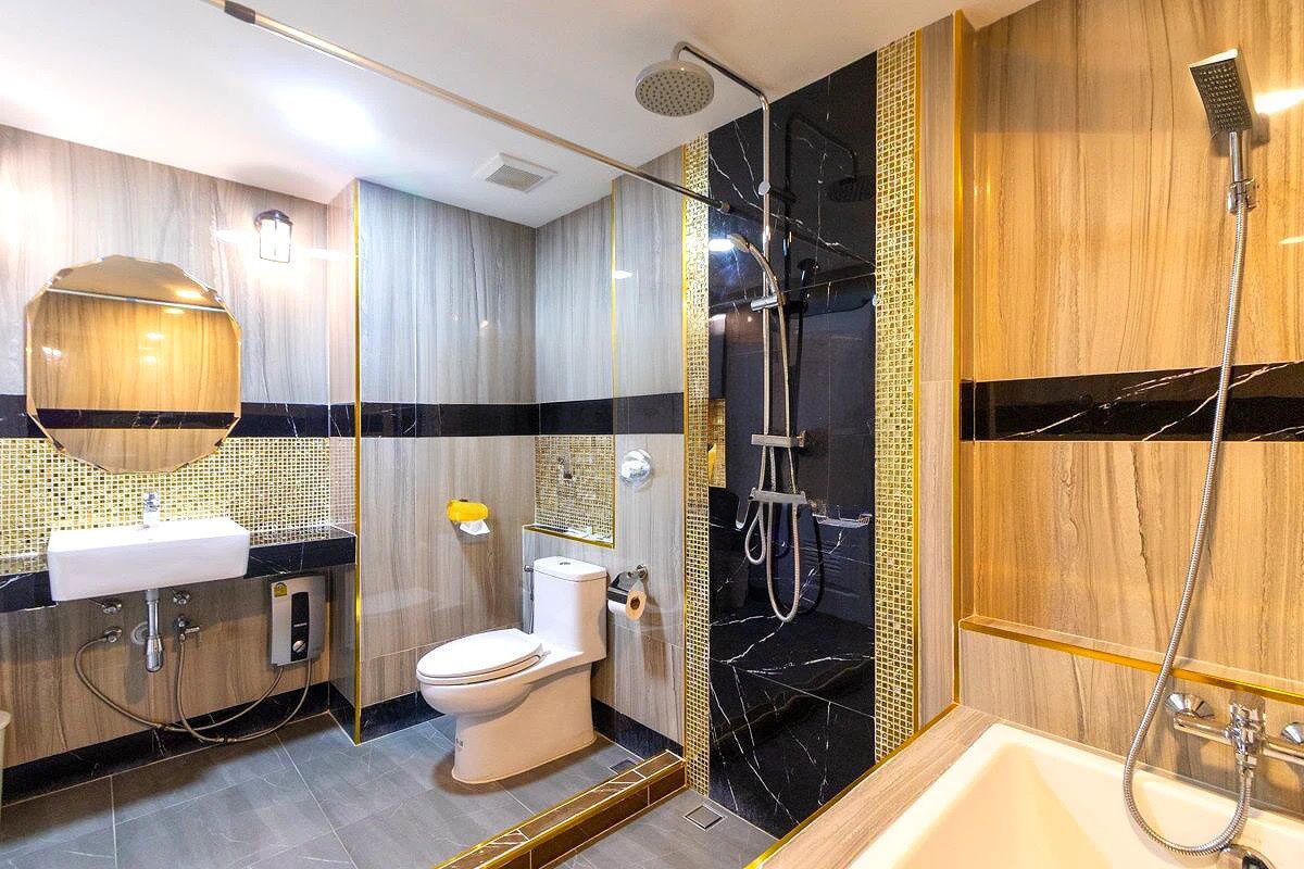 A modern bathroom with a toilet, sink, and shower.