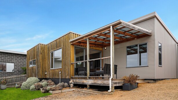 A modern two-story house with a wooden facade, large windows, and a covered porch. - Igneous Ridge - Calm and Quiet Retreat (Port Fairy)