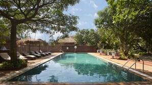 A swimming pool with lounge chairs and a '4FT NO DIVING' sign. - LaRiSa Resort & Spa, Ashwem (Ashvem)