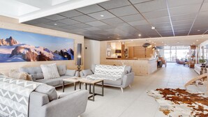 A spacious living area with a large sofa set, a coffee table, and a cowhide rug.