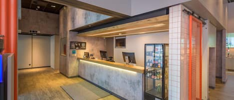 A reception area with a counter, a glass display case, and a wooden floor.