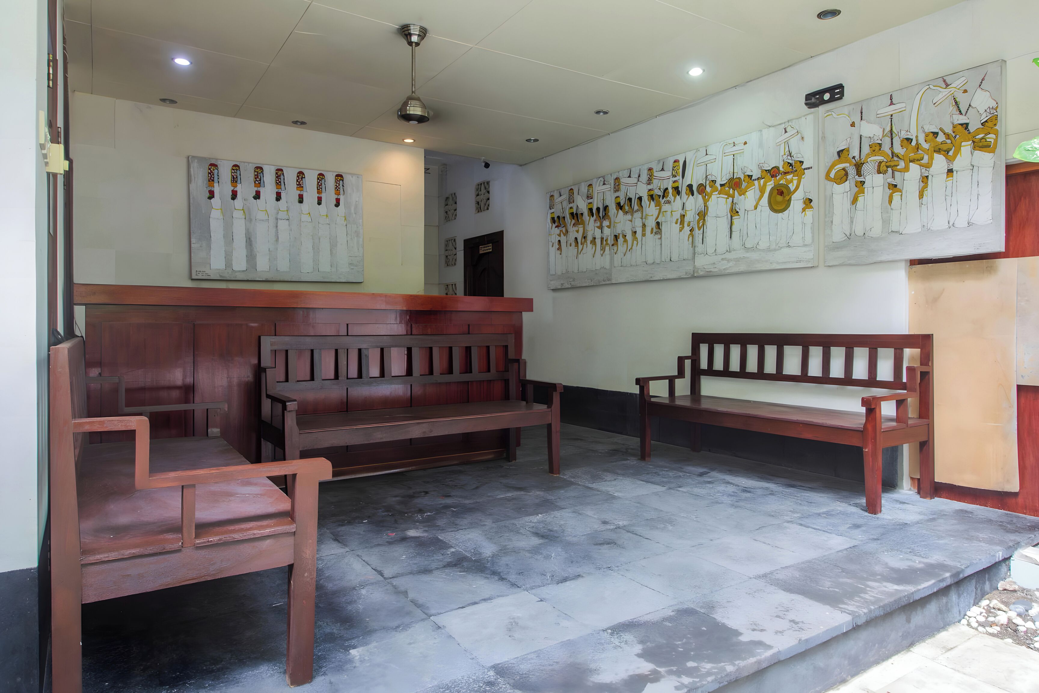 A waiting area with benches and a reception desk.
