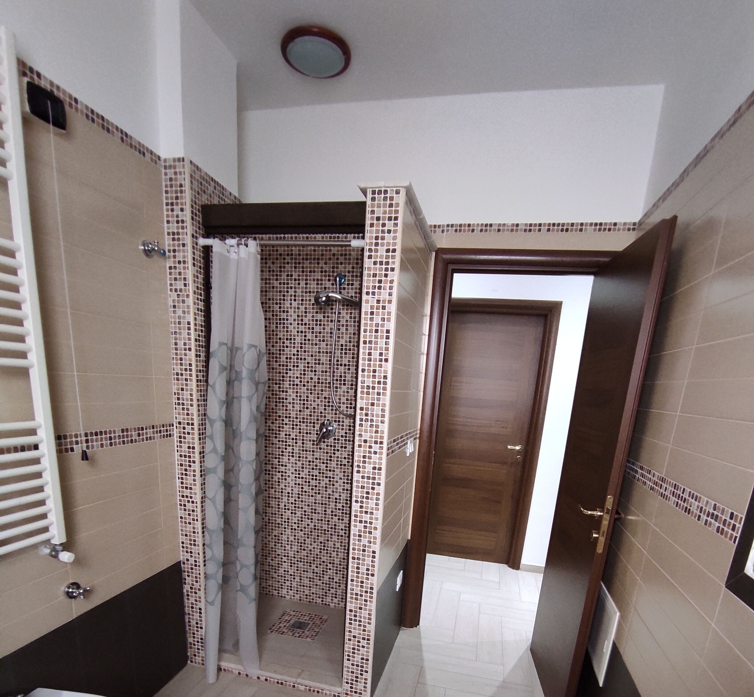 Une salle de bain avec une douche, des toilettes et un lavabo.