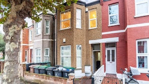 A row of terraced houses with a tree in the foreground.