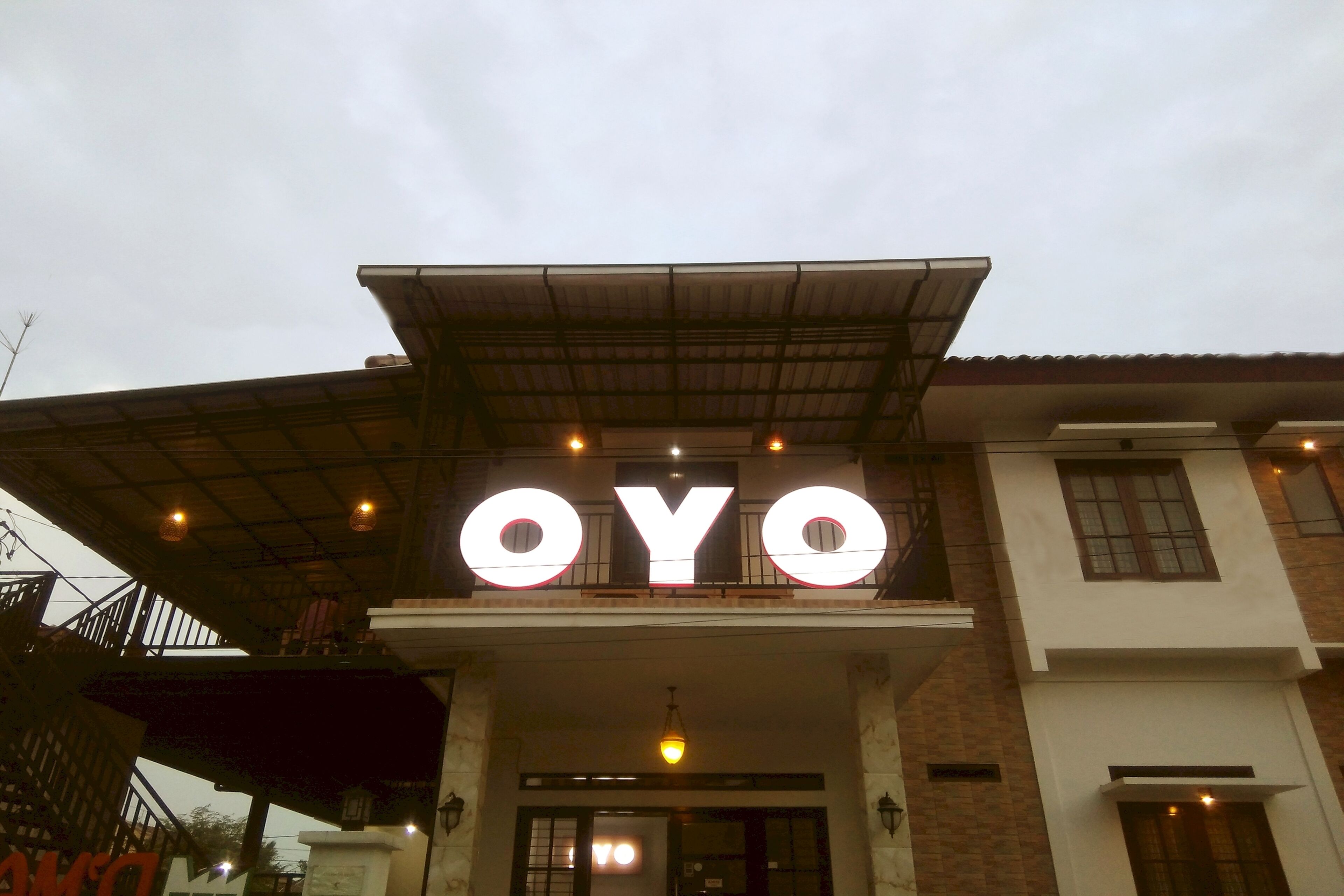 A building with a prominent "OYO" sign above the entrance.