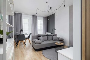 Relax in this stylish living space with a sofa set, dining area, and side table.