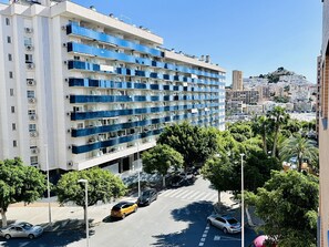 A multi-story hotel with balconies, a parking lot, and a view of a hill with buildings. - A1047 - Nice apartment in a complete urbanisation and close to the beach (Villajoyosa)
