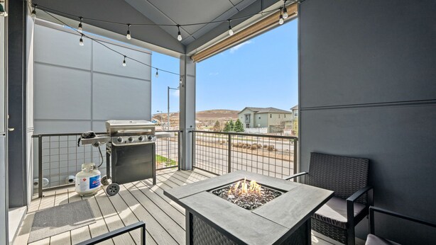 A balcony with a grill, a fire pit, and a view of the landscape. - Awesome Balcony | Near Denver & Boulder (Broomfield)