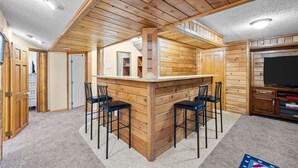 A wooden bar area with a high ceiling and built-in seating. - New! Recently Updated- Near Parks & Rec Center, Fenced Yard- 30 Day Rental (Littleton)