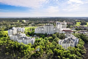 A large, multi-story hotel complex surrounded by lush greenery and a golf course. - 🌊 Your Serene Sandestin Sanctuary 🌴 (Miramar Beach)