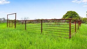 A metal gate in a grassy field with a clear sky. - Expansive Ranch on 2,001 Acres | Shared Pool & Hot Tub + Trails (Johnson City)