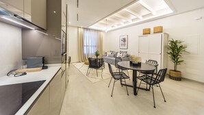 A modern kitchen with a dining area, a sofa, and a cabinet. - Cozy apartment in Marbella Old Town (Marbella)