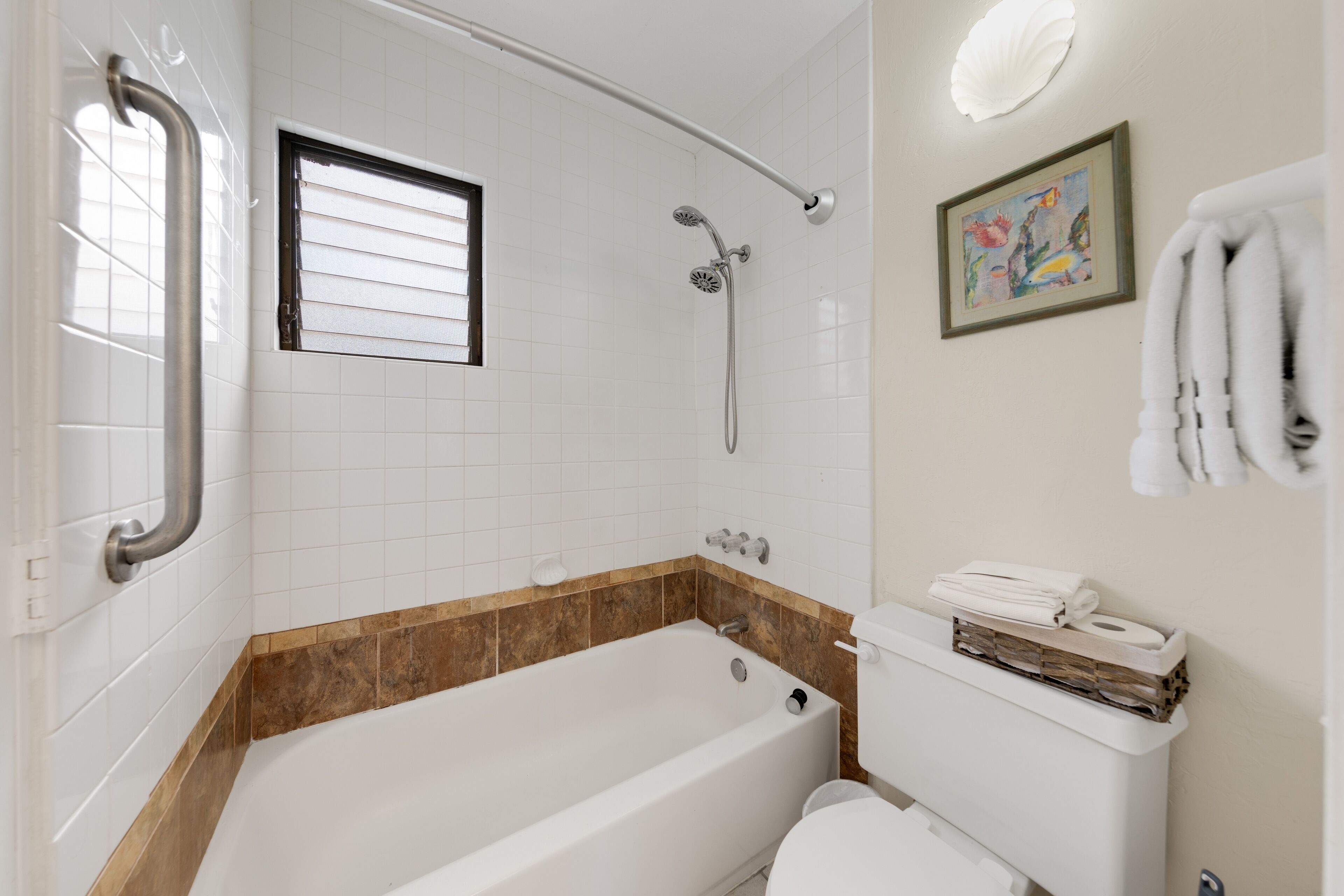 A bathroom with a bathtub, toilet, and a shower.