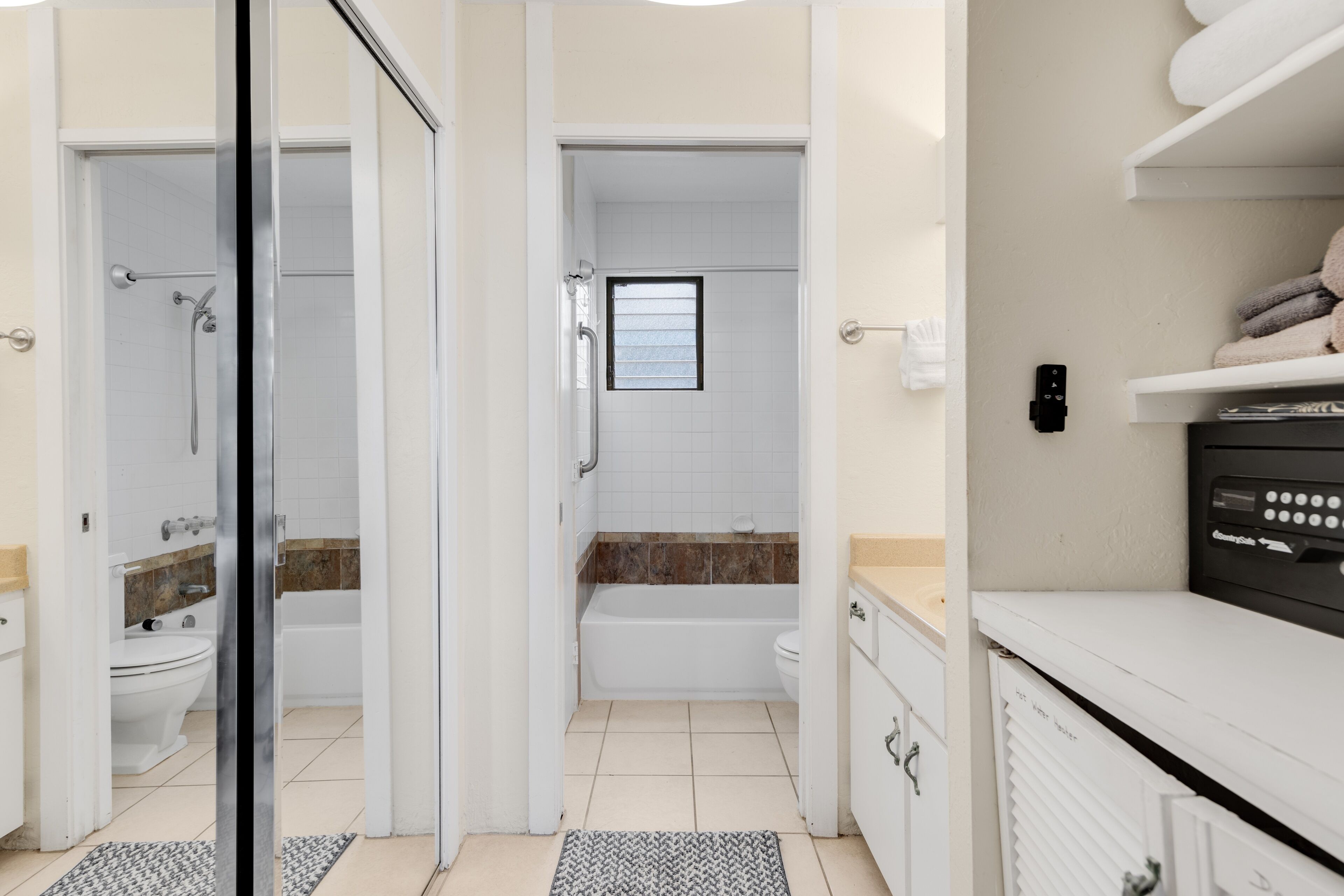 A modern bathroom with a shower, toilet, and bathtub.
