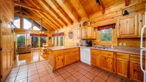 A spacious wooden cabin with a large kitchen, dining area, and a cozy living room. - Ern812 - Eagles Perch 2 Bedroom Cabin by RedAwning (Sevierville)