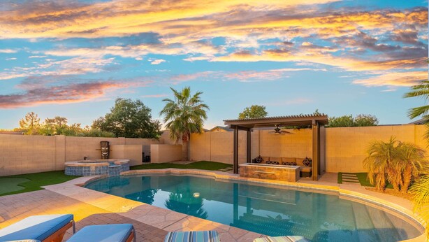 A swimming pool with lounge chairs, a hot tub, and a pergola. - Backyard Oasis! Group-friendly San Tan Valley Home (San Tan Valley)
