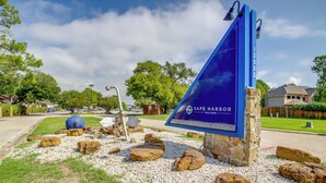 A blue sign with "SAFE HARBOR WALDEN" written on it, surrounded by rocks and pebbles. - Chic Montgomery Condo w/ Balcony + Pool Access! (Montgomery)