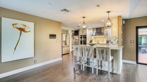 A modern kitchen with a central island, stainless steel appliances, and pendant lighting. - Near Golf & Beaches: Coral Springs Home w/ Yard! (Coral Springs)