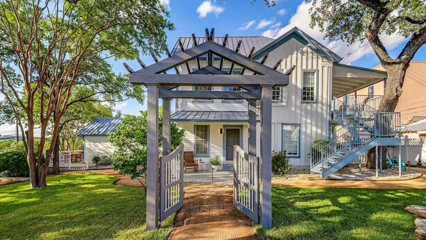 A house with a covered porch and a staircase leading to a deck. - 25% Off August! Austin Suite, 1 Block To Downtown* (Marble Falls)