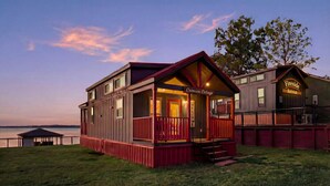 A two-story building with a porch, labeled 'Crimson Cottage,' and a separate building labeled 'Fireside Retreat.' - Lake Front Cottage Paradise! (Pittsburg)