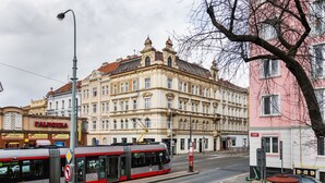 A tram on a city street with historic buildings in the background. - City Buzz Apartment - O2 Arena - Sleeps 6 (Prague)