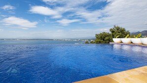 A swimming pool with a view of the sea and distant buildings. - Castell Mar 1012 - Studio Apartment, Sleeps 2 (Roses)