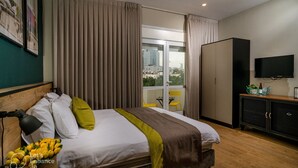 A hotel room with a bed, a TV, a wardrobe, and a balcony with a city view. - Dizengoff square boutique (Tel Aviv)