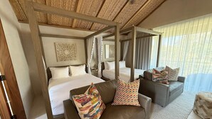 A spacious bedroom with a large bed, a sofa, and a daybed.