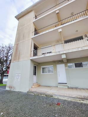 A multi-story building with balconies, a door, and a small window. - Bernardo's Place (Ponta Delgada)