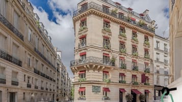 Classic building with a symmetrical facade, featuring evenly spaced windows and balconies.