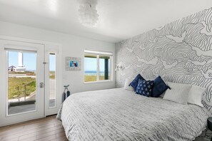 Un dormitorio con una cama grande, vistas al exterior y una pared con diseño topográfico.