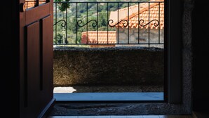 An open door leading to a balcony with a view of distant mountains and terraced fields. - D'Autor Village (Baiao)