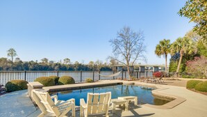 A swimming pool with lounge chairs and a hammock. - Riverfront North Augusta Home w/ Private Pool! (North Augusta)