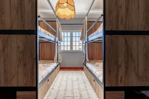A bunk room with two bunk beds, a hanging light fixture, and a window with a view. - Hostel Idanha, Idanha-a-nova (Idanha a Nova)