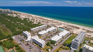 An aerial view of a coastal hotel complex with multiple buildings, parking areas, and a beach. - Gulf Shores Plantation IV (Gulf Shores)