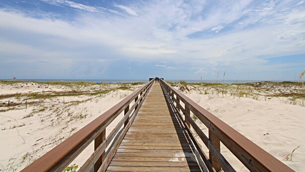 A wooden boardwalk leading to a beach with dunes and a clear sky. - Gulf Shores Plantation IV (Gulf Shores)