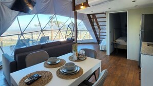 A tent with a dining area, kitchen, and sleeping quarters. - The Domes Jarabacoa (Jarabacoa)