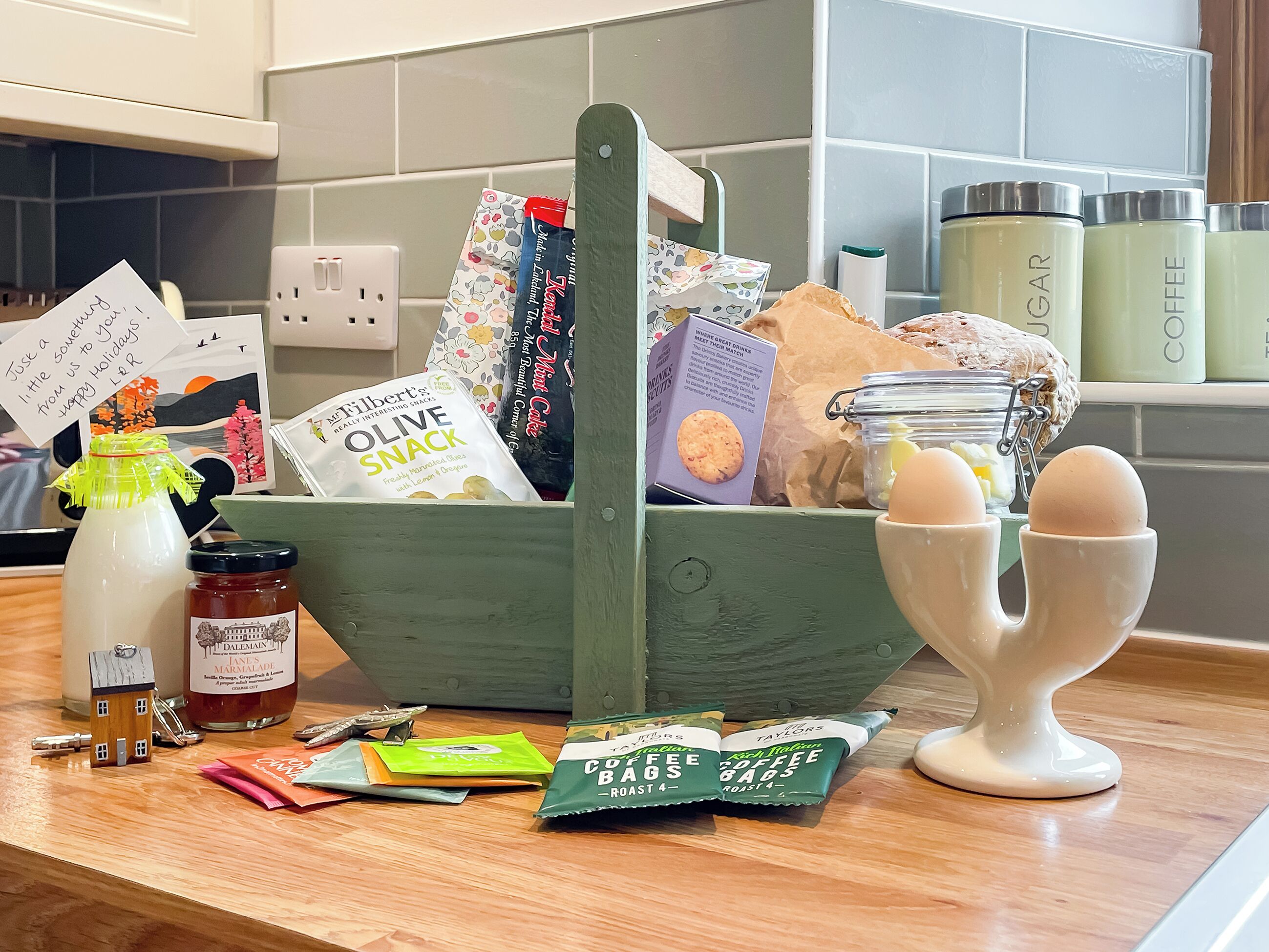 A kitchen counter with a variety of food items and kitchen utensils.