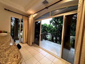 Enjoy a serene view from the balcony surrounded by lush greenery.