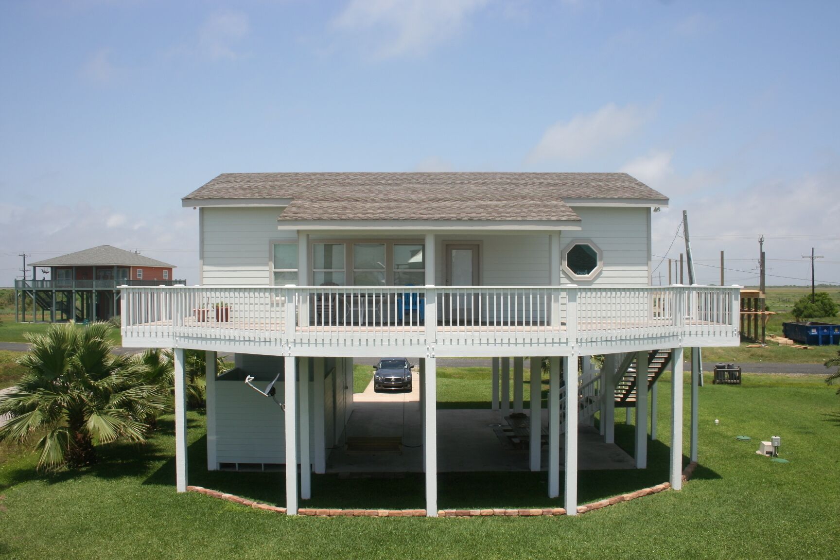 A two-story house with a balcony and a covered porch.