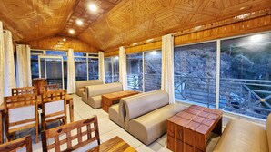Un interior de madera con asientos y ventanas amplias.