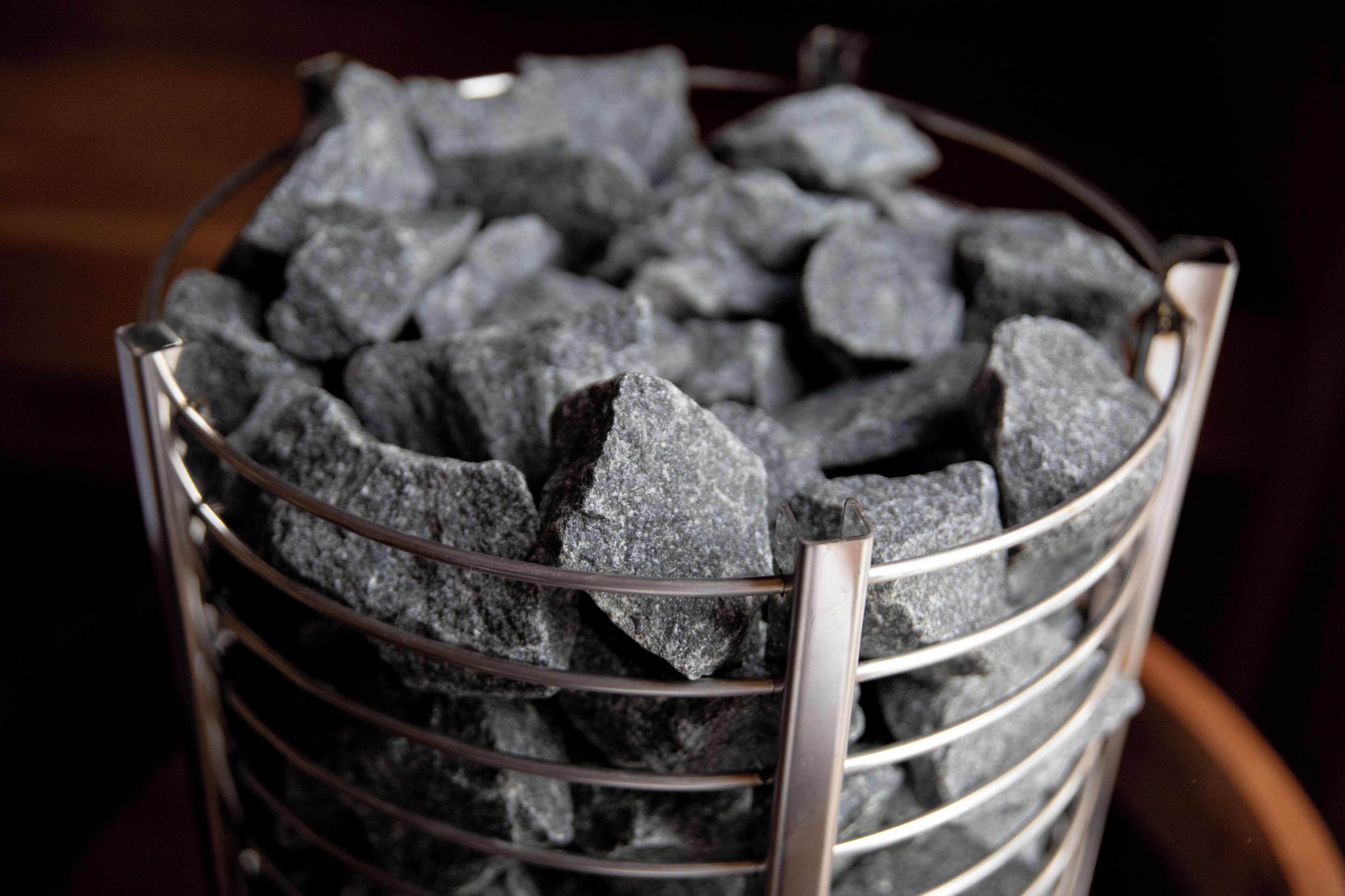 A metal basket filled with charcoal briquettes.