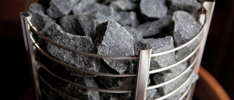A metal basket filled with charcoal briquettes.