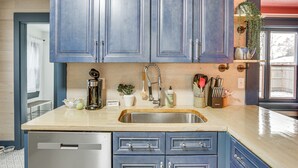 A kitchen with blue cabinets, a stainless steel sink, and a wooden countertop. - Charming Minneapolis Home w/ Deck, 5 Mi to Central (Minneapolis)