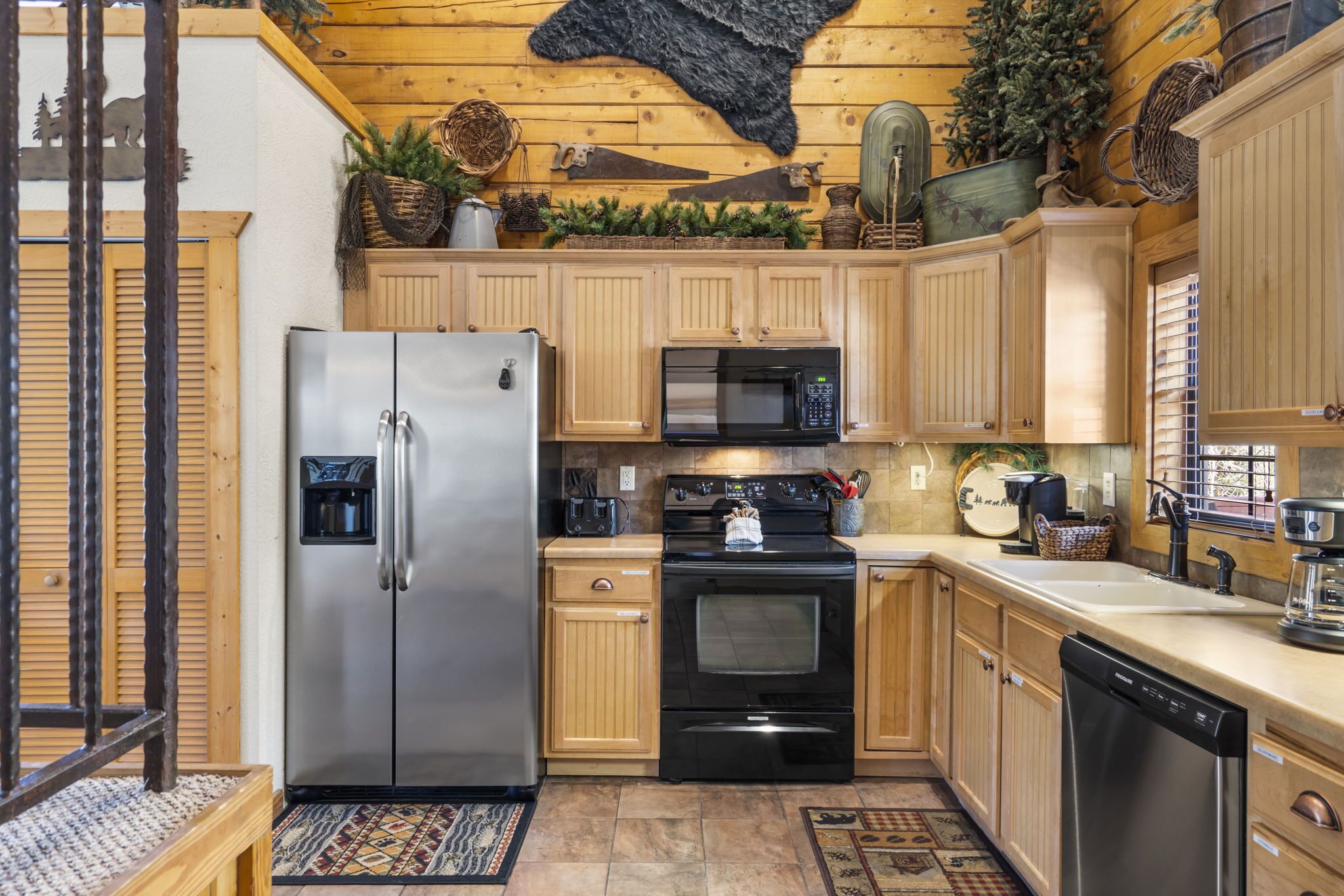 A kitchen with wooden cabinets, stainless steel appliances, and decorative items on the wall.