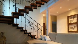 A modern living room with a staircase, a sofa, and a coffee table. - Holiday Home Mirta - Three Bedroom Holiday Home with terrace (Murter)