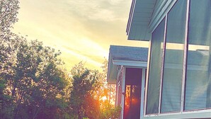A house with a front porch, a lawn, and a garden. - Sea Bisquit Cottage by the Ocean (Scarborough)